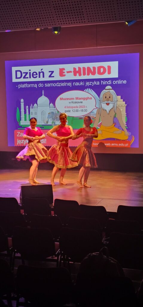 Trzy tancerki tańczą, w tle slajd z joginem i Tadż Mahal